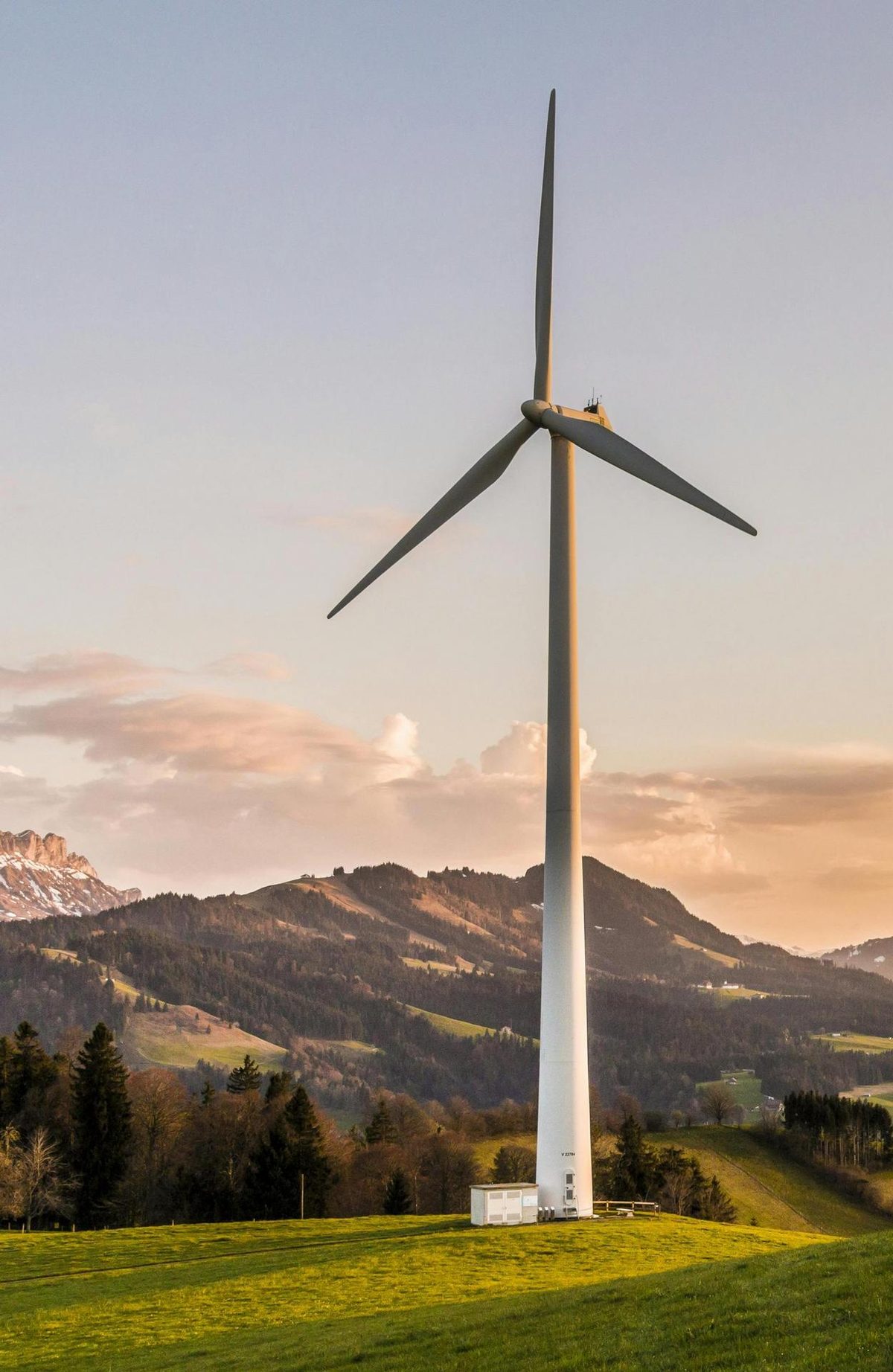 Wind turbine in rolling landscape at dusk