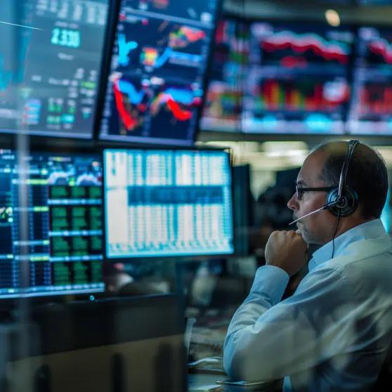 Energy trader monitoring live market data across multiple screens