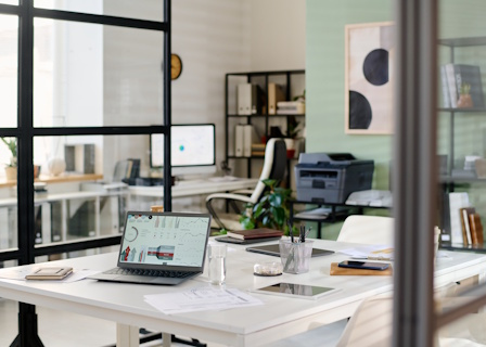 Joan D'Angelo's workspace — laptop and desk in a bright studio office